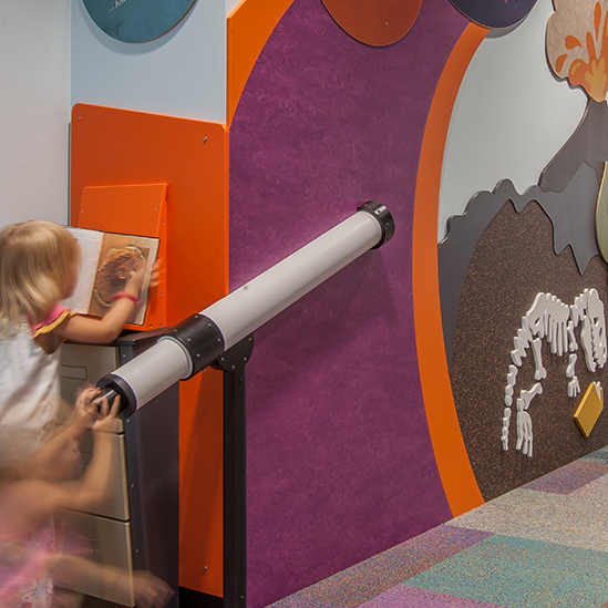 children playing with a giant magnifying glass